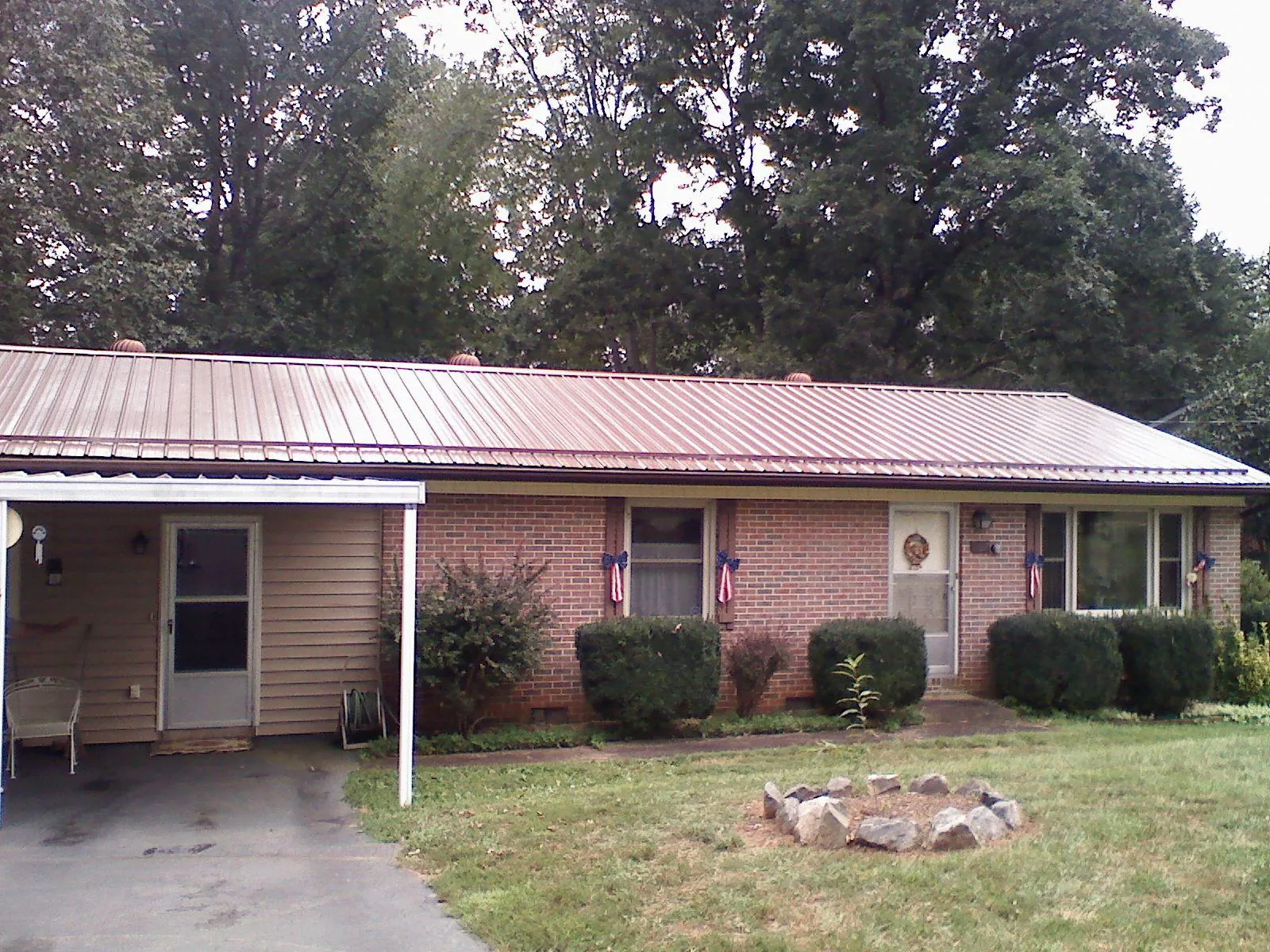 Bronze metal roof and carport on a brick ranch home — Roof Repair work by our crew in Cordova